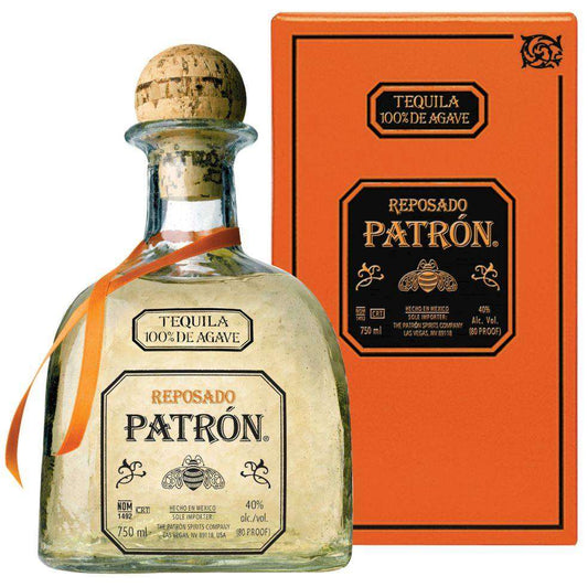 Patrón Reposado tequila bottle with orange ribbon and box on a white background