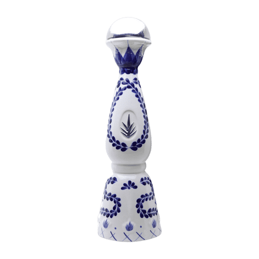 White ceramic pepper grinder with blue floral patterns on a green background